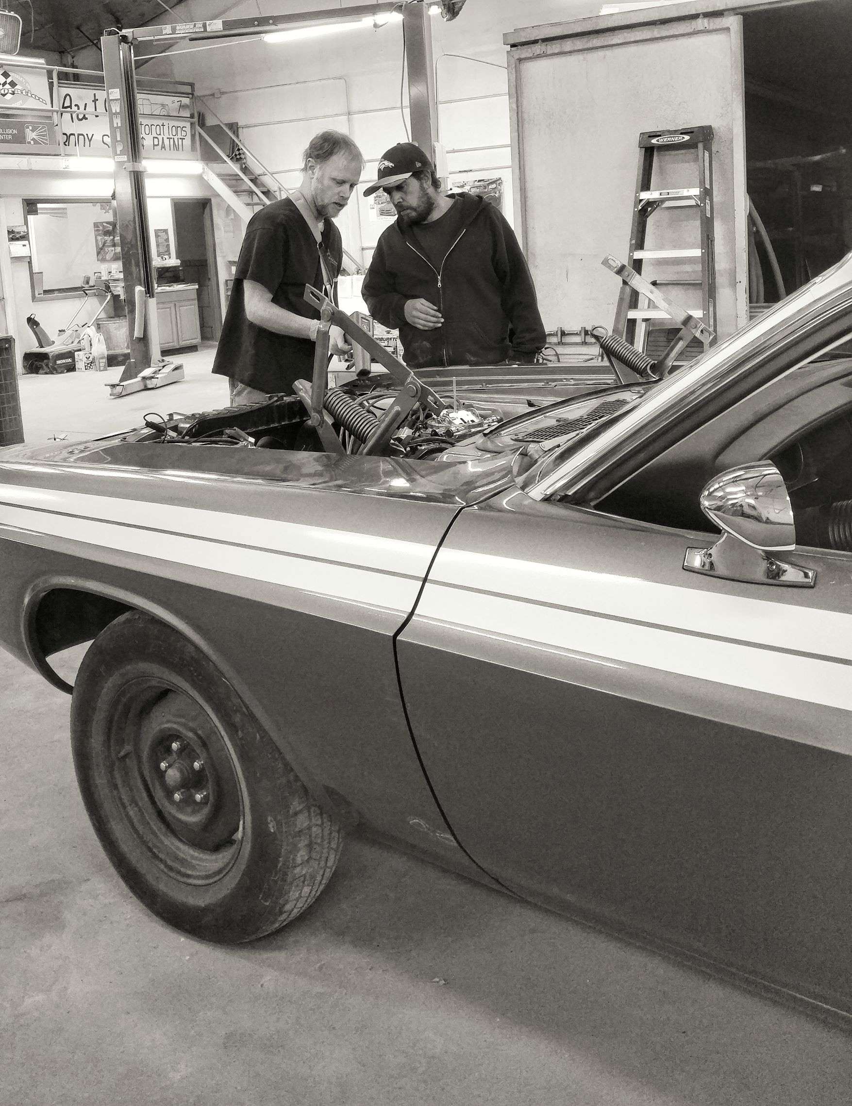  of our staff members working on a classic car restoration. 